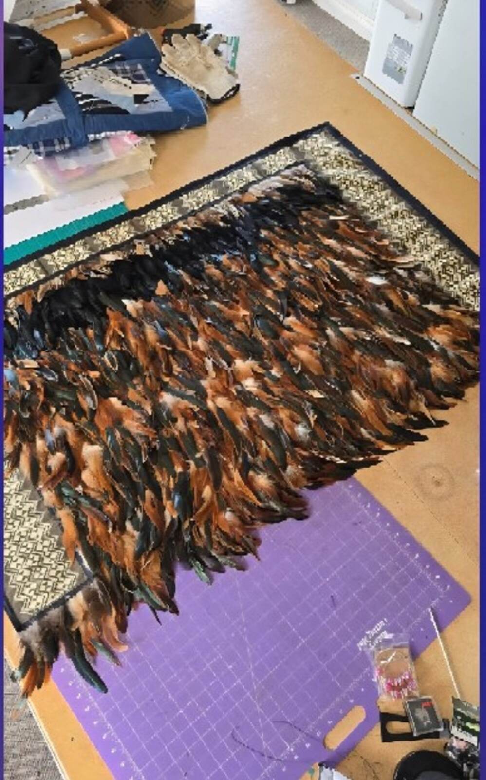 A korowai, a feathered cloak, laid out flat