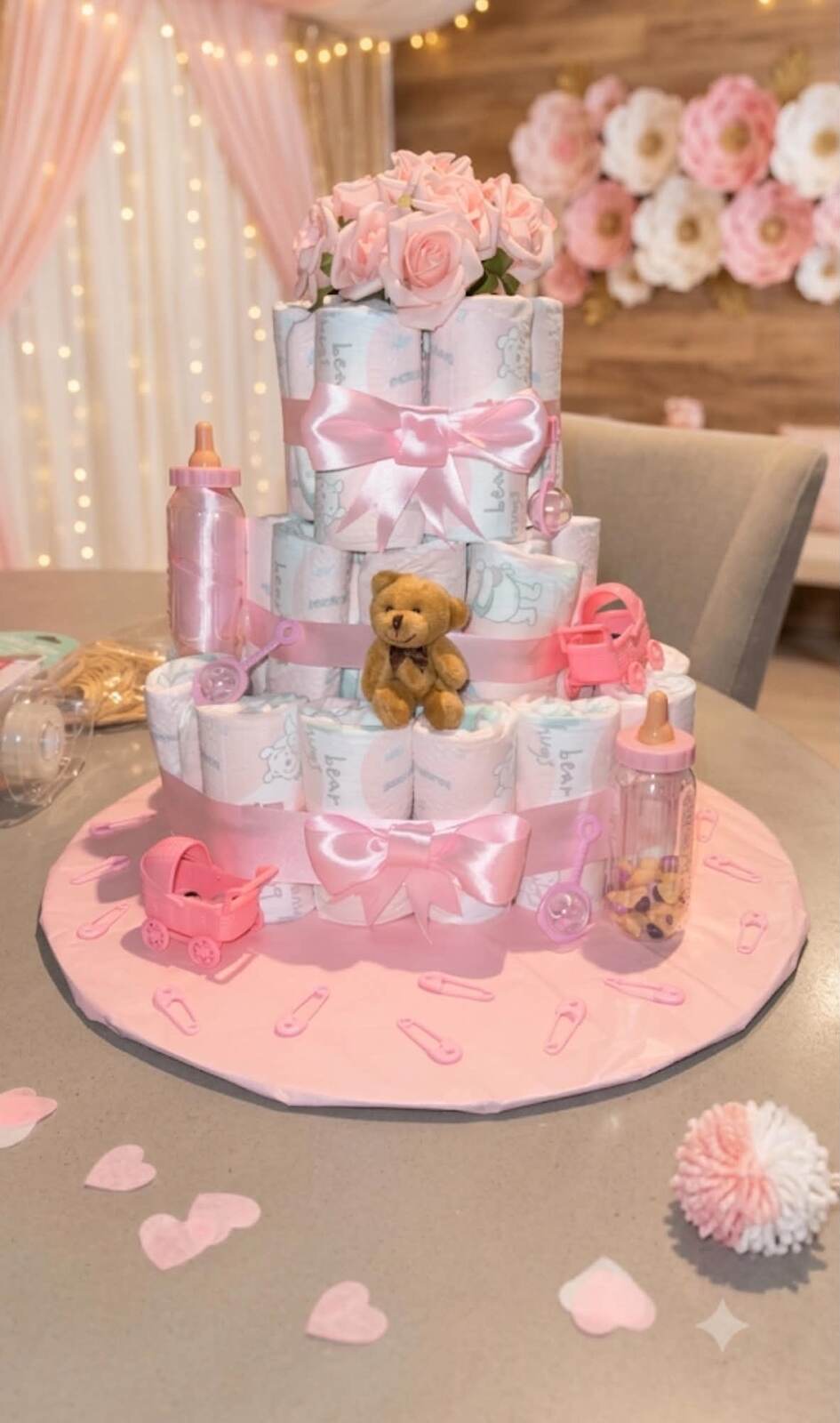 Honey's own photograph of her three tier nappy cake with pink ribbon, roses and a teddy